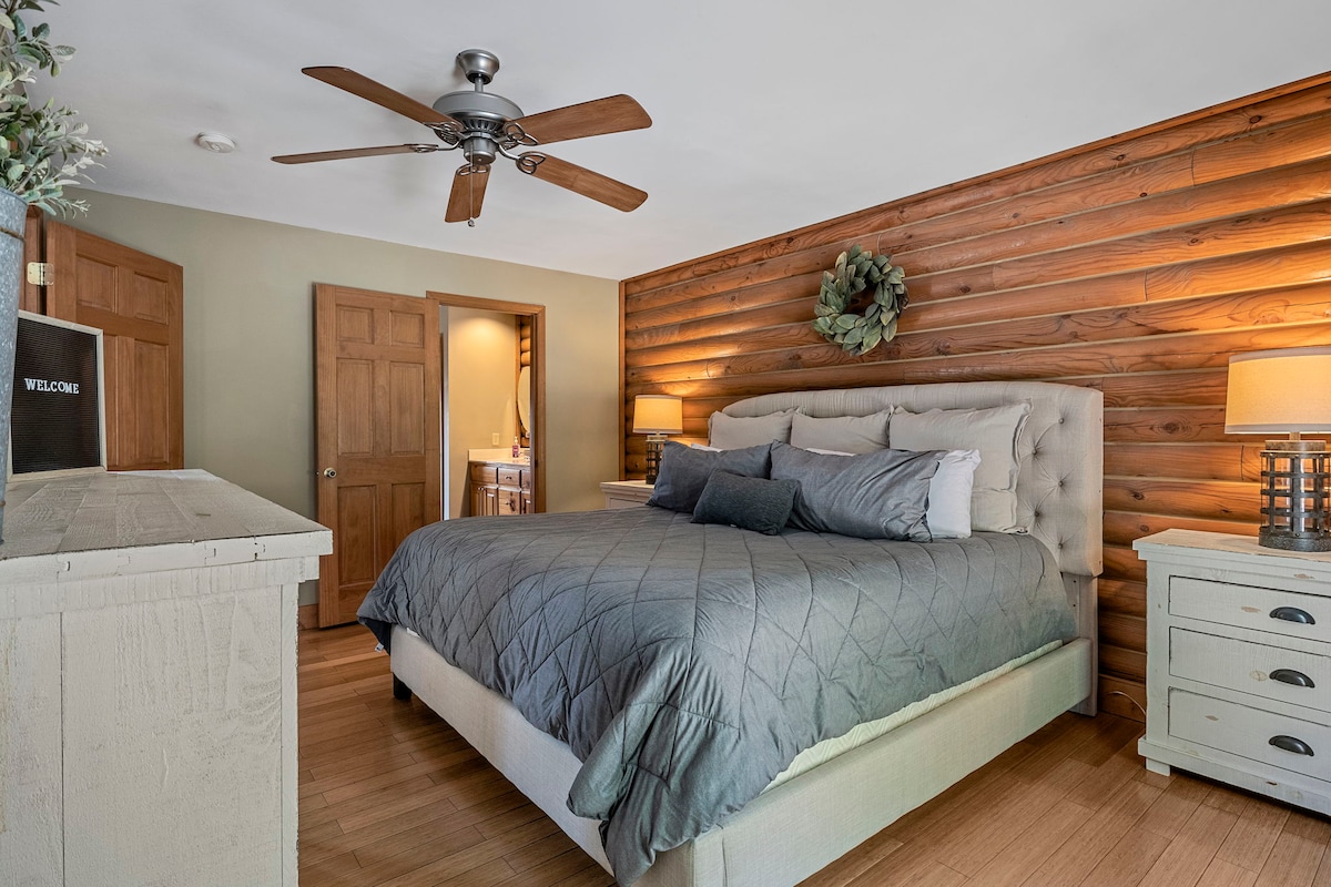 Master bedroom with a king bed, full bathroom attached, and walk out doors.