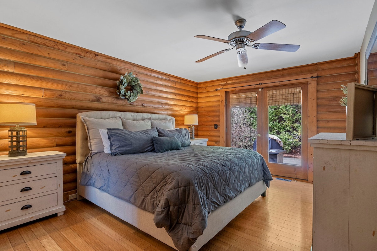 Master bedroom with a king bed, full bathroom attached, and walk out doors.