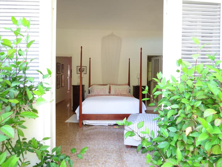 Bedroom 4 (pencil-post bed & 2 singles, opening directly to garden and pool)