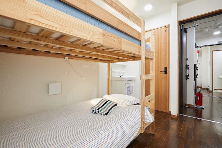 Room with bunk bed, vanity and toilet room