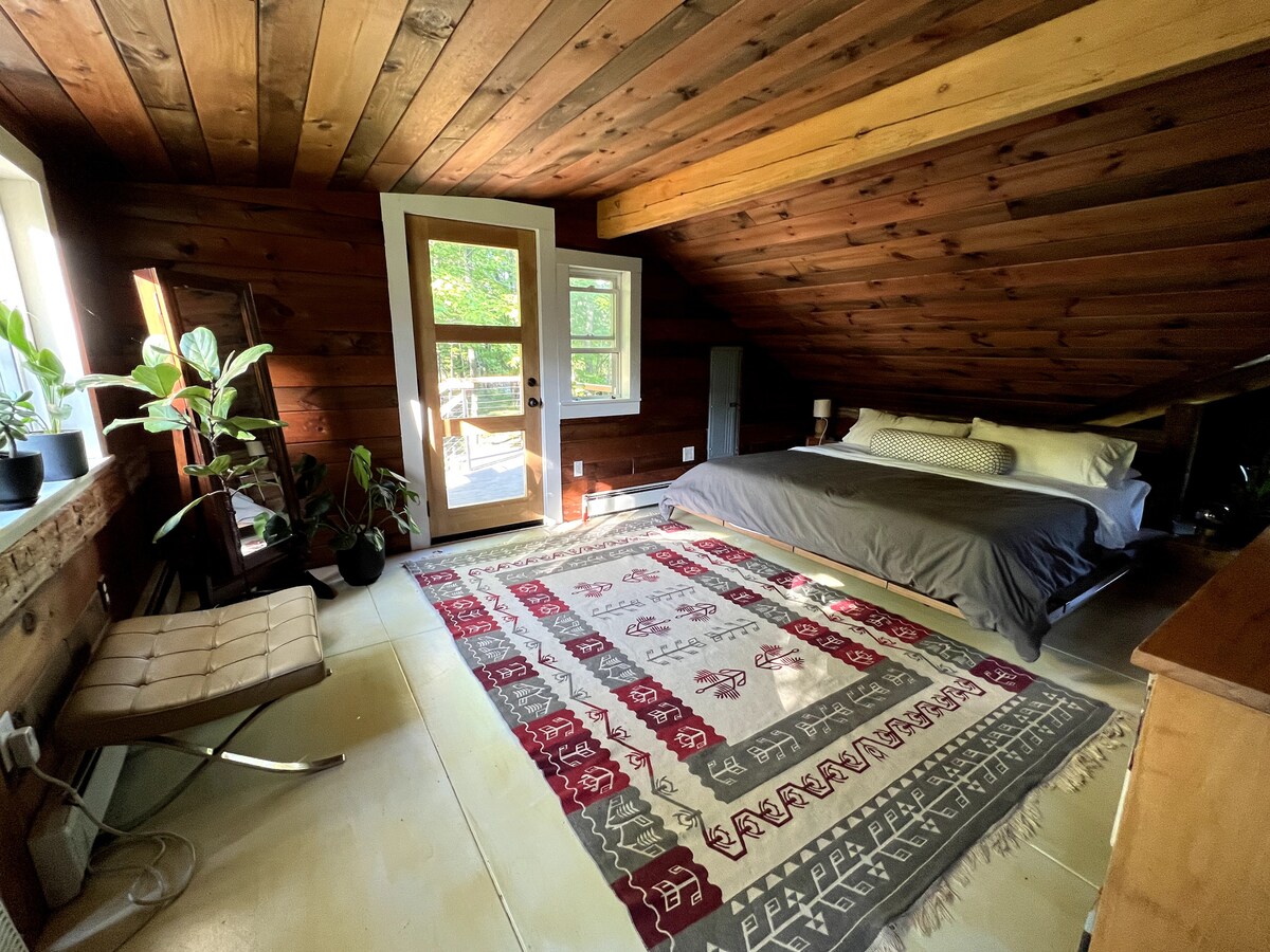 Primary bedroom upstairs with a king bed. It's like a treehouse for adults