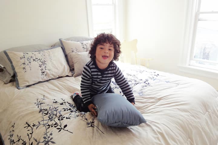 Master bedroom with plenty of sunlight and comfortable, firm queen bed, and 55" Roku 4K TV (3-year-old not included)