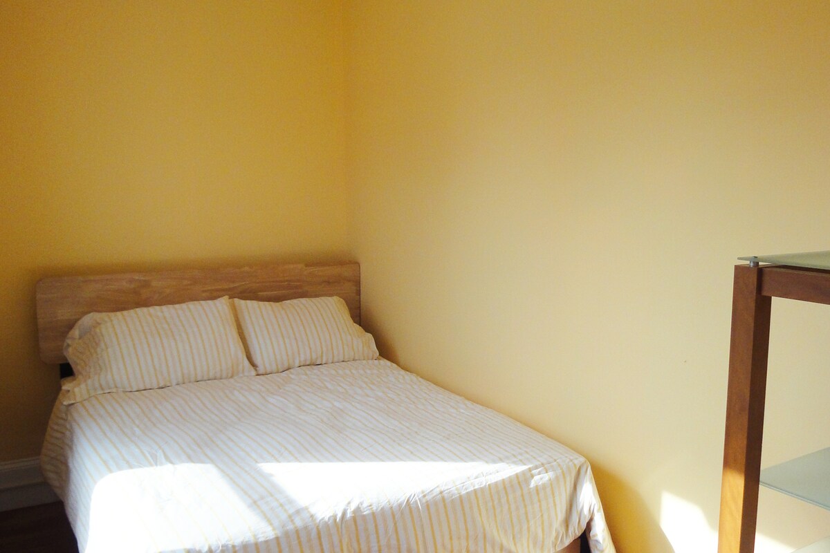 Small second bedroom with comfortable, firm double bed and sunny south-facing window overlooking a pretty Trumbull Road street scene