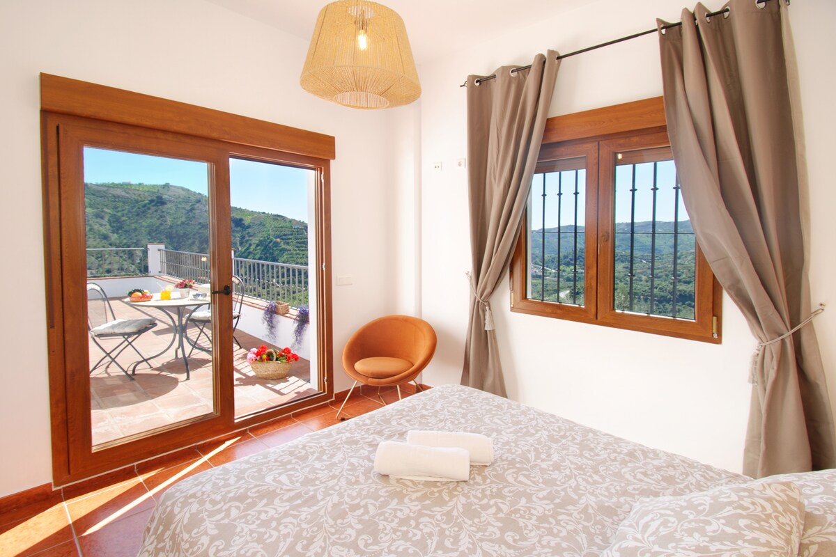 One of the bedrooms, with doors to the terrace and exceptional views!