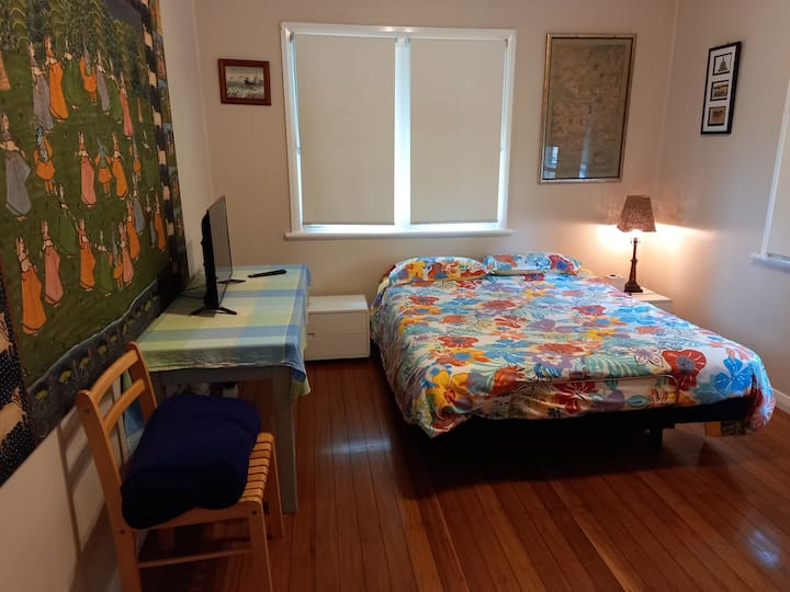 Queen bedroom with desk and chair and wardrobe. 
