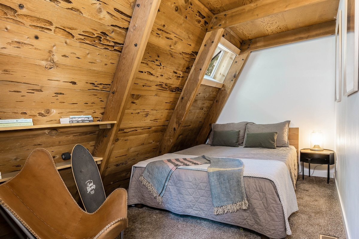 Main floor bedroom has a queen bed with luxury bedding. 