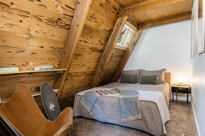 Main floor bedroom has a queen bed with luxury bedding. 
