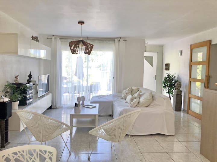 View of the dining room towards the living room overlooking the terrace with the door to the corridor of the sleeping area on the right. 
120 cm sofa bed and 2 comfortable designer armchairs 
Raisable coffee table, flat screen TV on removable arm 

