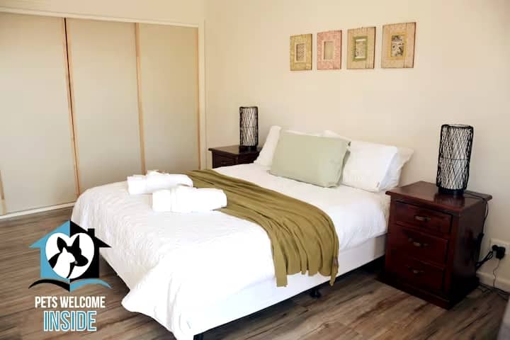 Dormitorio con cama tamaño queen y albornoces empotrados