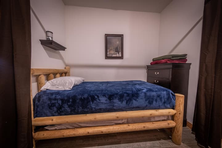 Amish-made Twin Bed, located on lower floor in alcove, with privacy curtains.