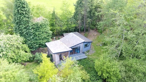 Mouse House set on the edge of a lake in Mid Wales