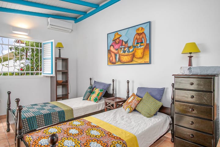 First room with two single beds