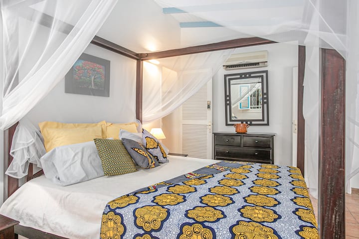 Large bedroom of bungalow 2 with its four-poster bed