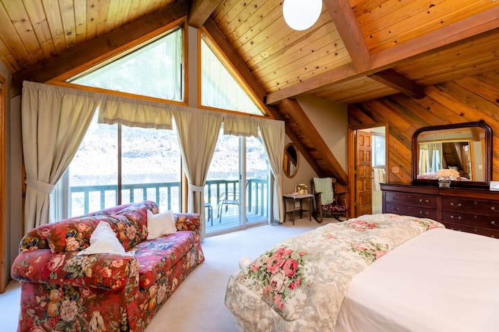 Master bedroom with en suite bathroom and balcony overlooking deck