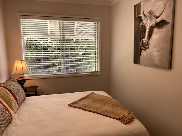 Double bedroom with ceiling fan and built in wardrobe