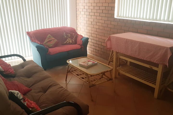 living room with couch, sleeper couch and  dinning table with stools