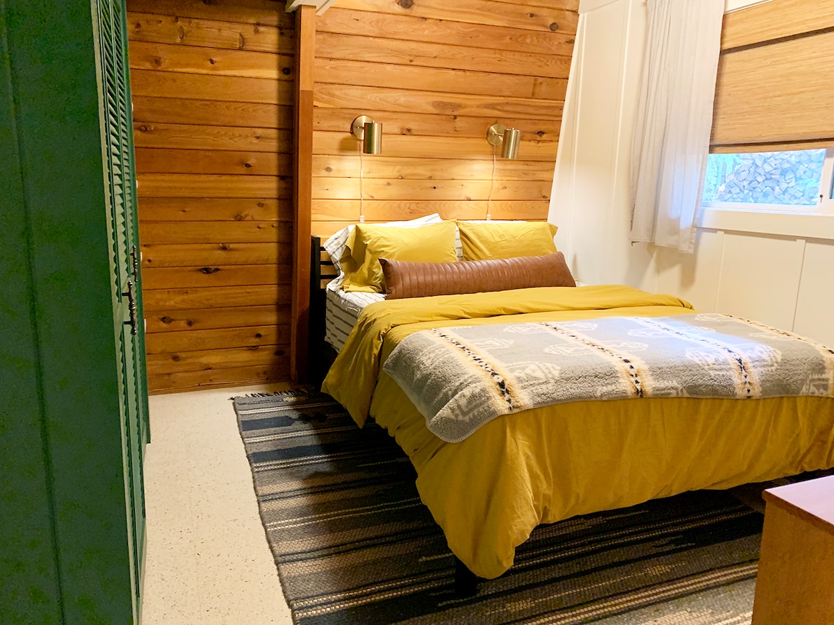 Escape to the inviting primary bedroom, complete with a cozy queen-sized bed, ensuring a restful night’s sleep during your stay at Arch House.