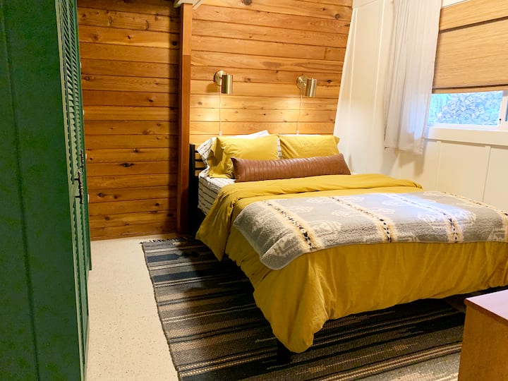 Escape to the inviting primary bedroom, complete with a cozy queen-sized bed, ensuring a restful night’s sleep during your stay at Arch House.