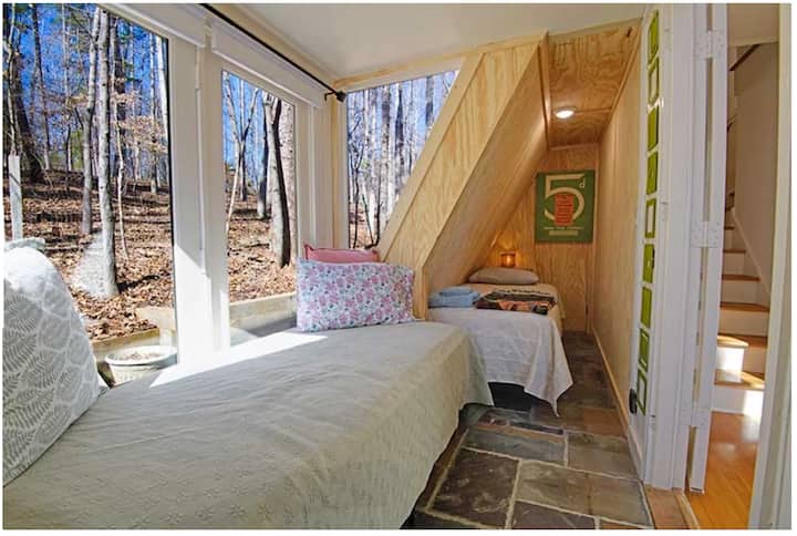 Glass room, adjacent to living room, with one single bed. Room has frosted glass door for privacy inside, and shades for privacy outside.  Slate flooring. Quietude.com