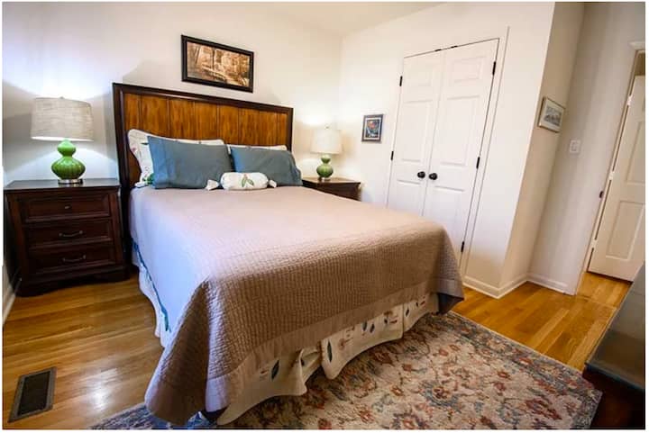 Bedroom with queen bed, ground floor in the back of the A-frame. Hardwood floors. Dedicated work space with desk. Quietude.com