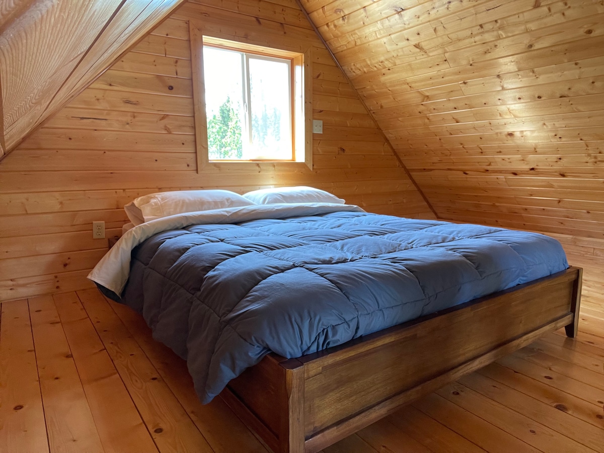 Cozy queen bed located in the loft.  We provide bedding and pillows.