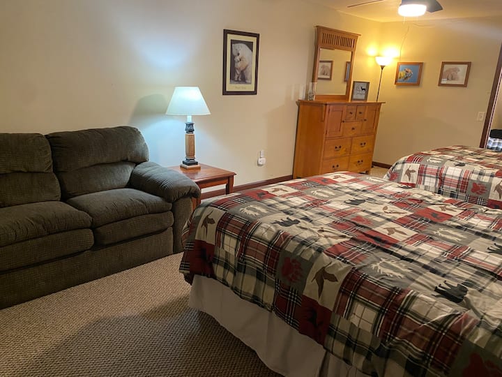 Downstairs bedroom with 2 queen beds and a love seat. 