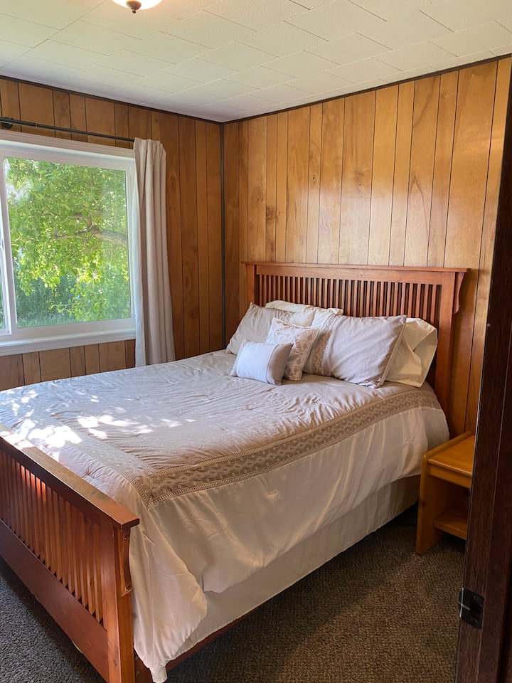 Upstairs bedroom with a queen bed. Bathroom located in the hall right outside the door. 