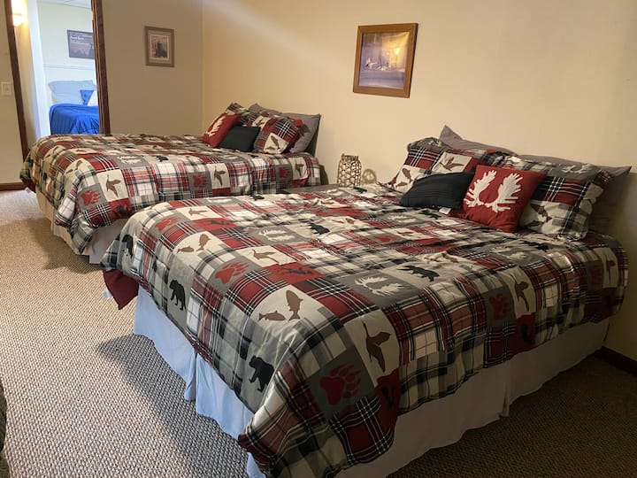 Downstairs bedroom with 2 queen size beds. Egresses to garage and living room. 