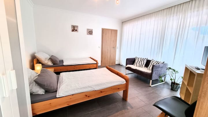 dhomë gjumi e vogël në apartament Mühlenbach me dalje në tarracë.