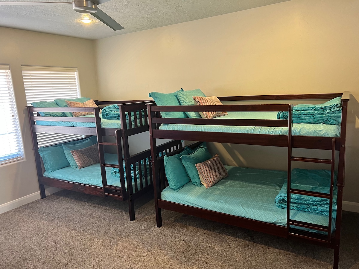 Kids loft with Wii U gaming system, bean bags, and two full-size bunk beds.