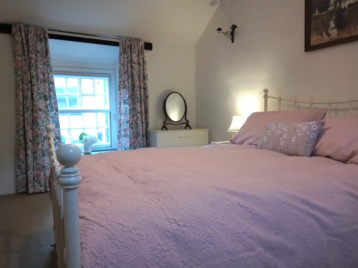 Large double bedroom with wardrobe and chest of drawers.
