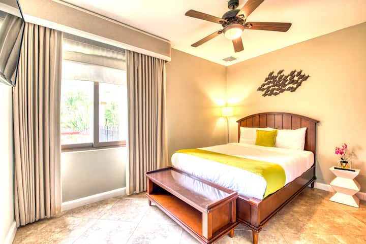 Second Bedroom has a large bed, flat LCD TV and an outdoor window.