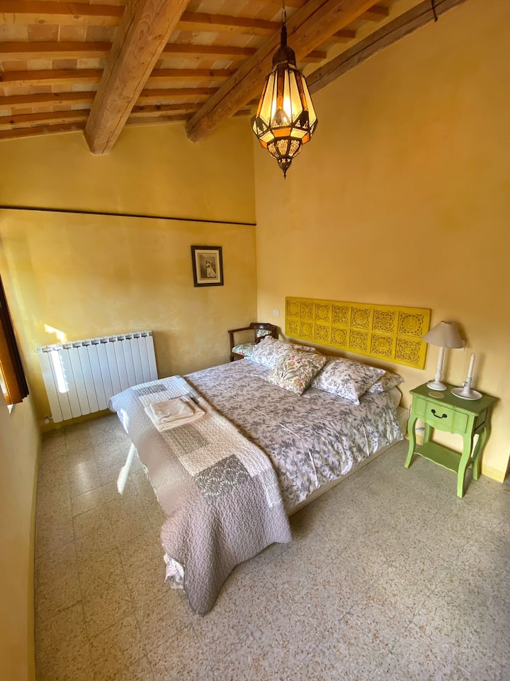 The Yellow room, sunrise, exposed beams, looking up towards the village of Santa Vittoria