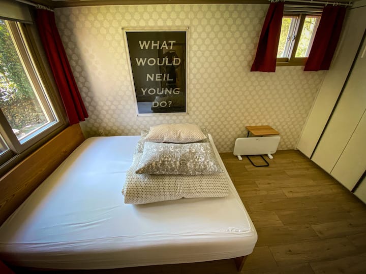 Private bedroom with king size bed and wardrobe/dresser.