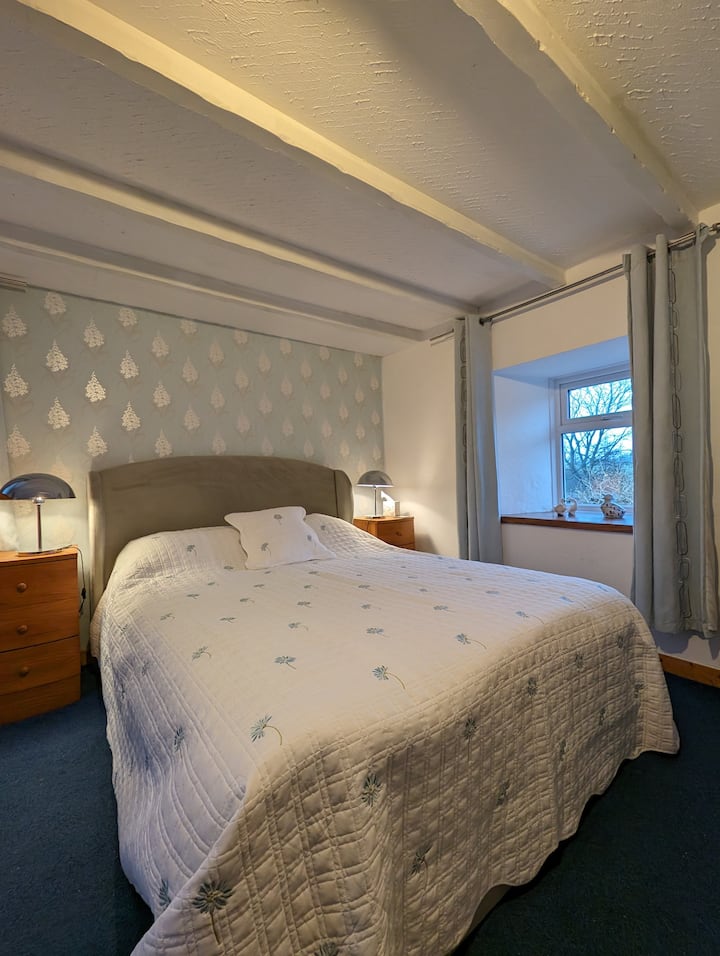 Downstairs family room, containing a kingsize double bed and a single bed. This large downstairs bedroom benefits from having an en suite shower, W.C. and washhand basin.