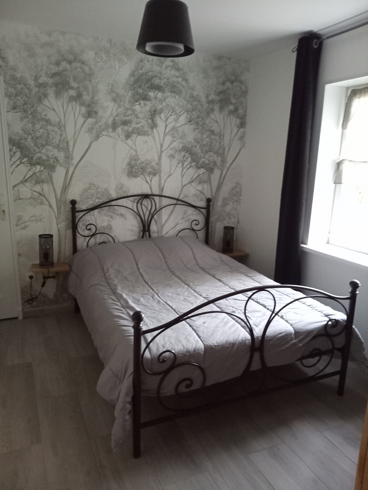 Druhá spálňa na prízemí s manželskou posteľou, triezvo a elegantnou atmosférou.