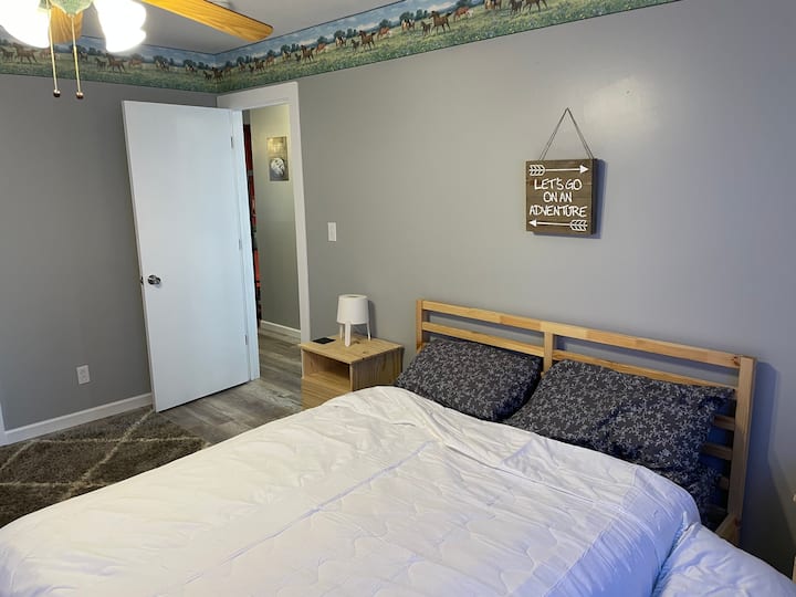 Our second bedroom features a beautiful and comfortable queen bed and raw wood furniture to accent the room.