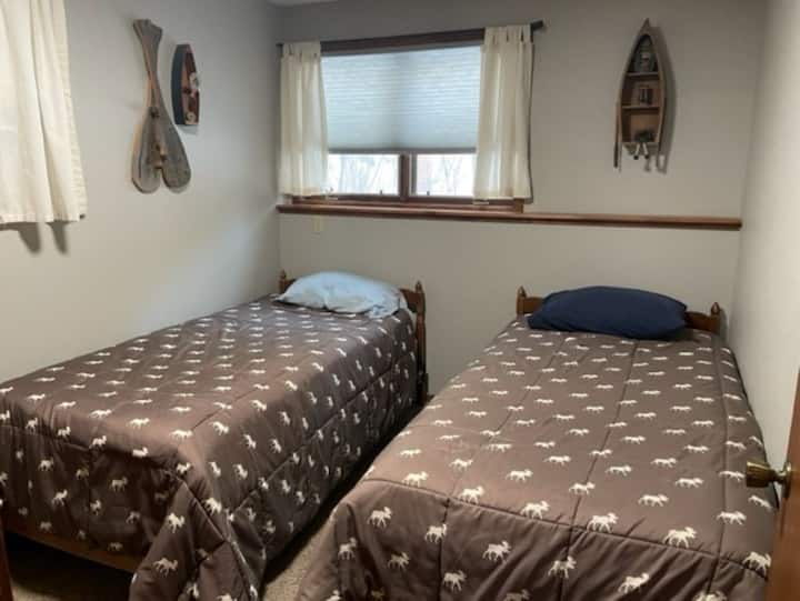 غرفة في الطابق السفلي مع توأمين