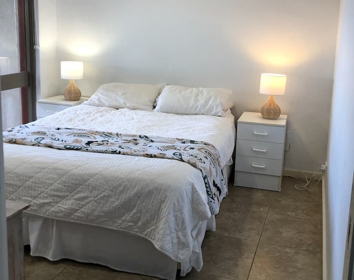 Fresh master bedroom with sliding doors to the river