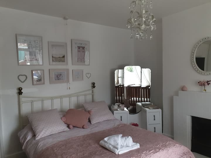 comfy double bed, original deco tiled fireplace and ornate vintage plaster mirror