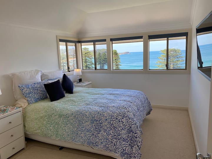 חדר שינה ראשי עם  נוף לים,טלוויזיה וחדר רחצה צמוד