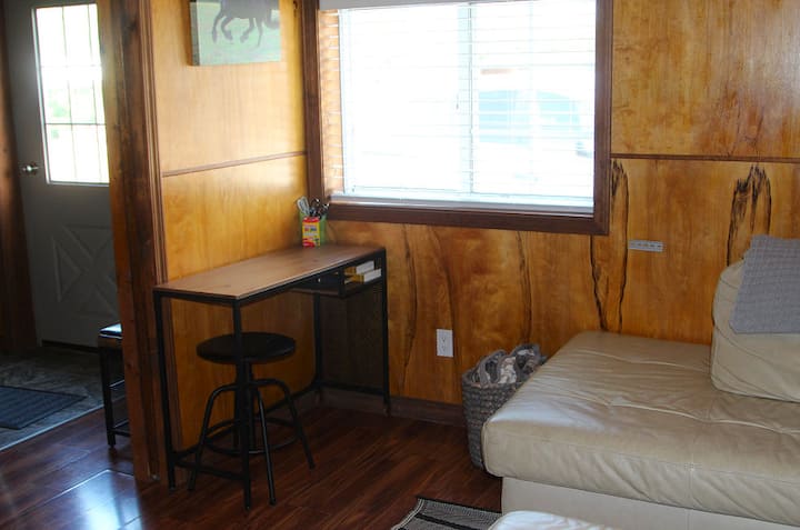 The computer desk is handy for a laptop with an outlet close