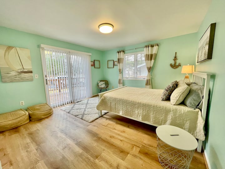 Main floor, 1st bedroom.  Queen memory foam mattress, sliding door access to front wrap around porch.
