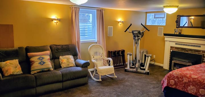 Spacious bedroom with pillow-top queen-sized bed large sectional, elliptical and cozy gas fireplace.