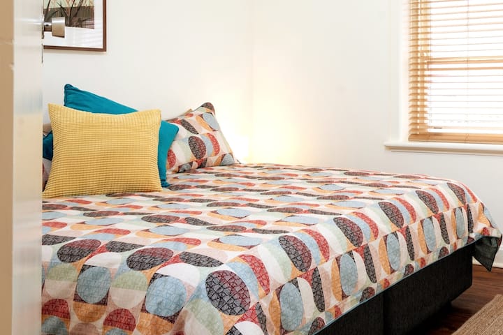 the second bedroom is cosy and inviting with a funky vaulted ceiling. 