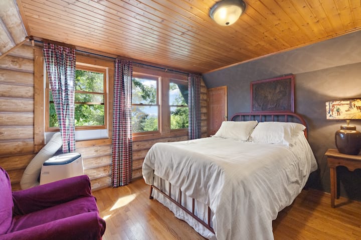 Upstairs full bedroom with closet and dresser storage, with BIG front of house views and AC unit in summer / additional portable fireplace in fall/winter.