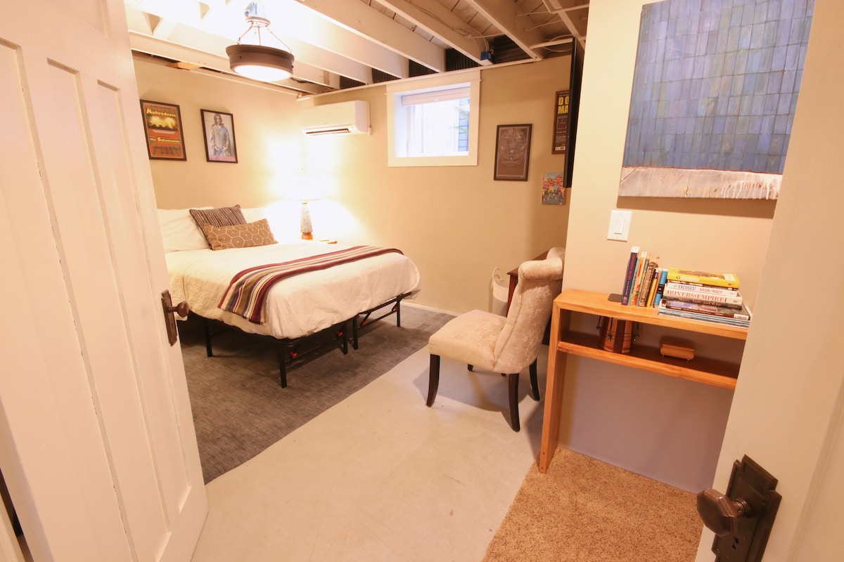 Basement bedroom (QUEEN). Double doors separate this room from basement rec. room. A curtain separates it from the laundry room. 