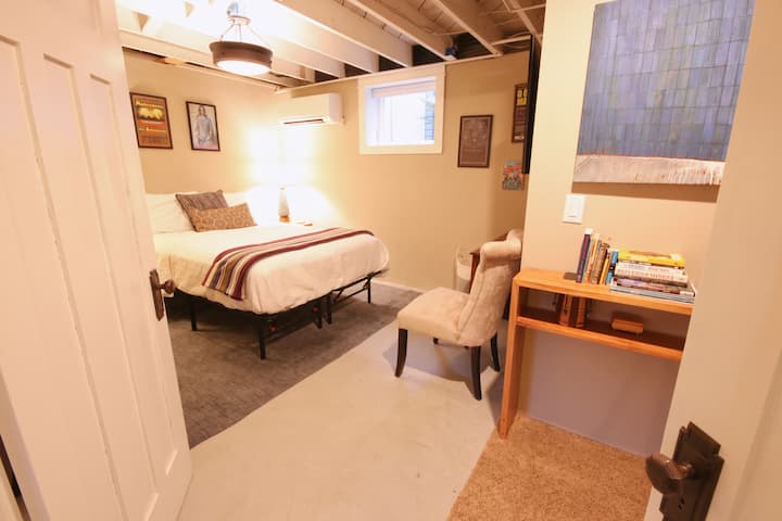 Basement bedroom (QUEEN). Double doors separate this room from basement rec. room. A curtain separates it from the laundry room. 