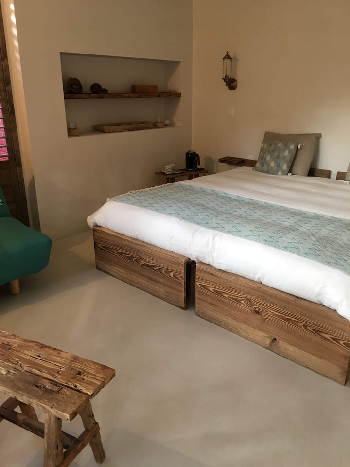 -Relax in this serene double bed bedroom, where natural light pours in, creating a bright and airy atmosphere.
-Convenient shelves on the side provide extra storage while adding a touch of style to your stay.