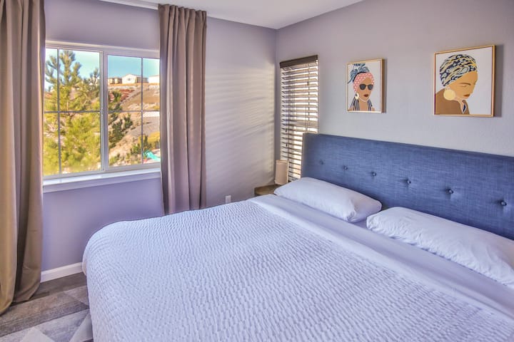 The second room provides a comfortable king mattress, soft pillows, white sheets, and a comforter, and black-out curtains/blinds to enjoy your night's rest.